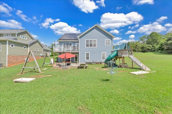 a view of a house with pool yard and outdoor seating