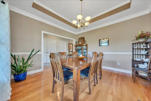 a view of a dining room with furniture and wooden floor