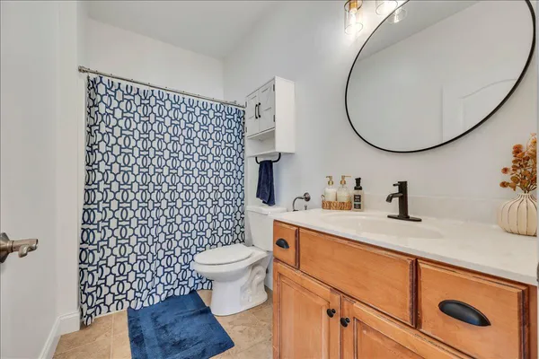 a bathroom with a sink toilet a mirror and vanity