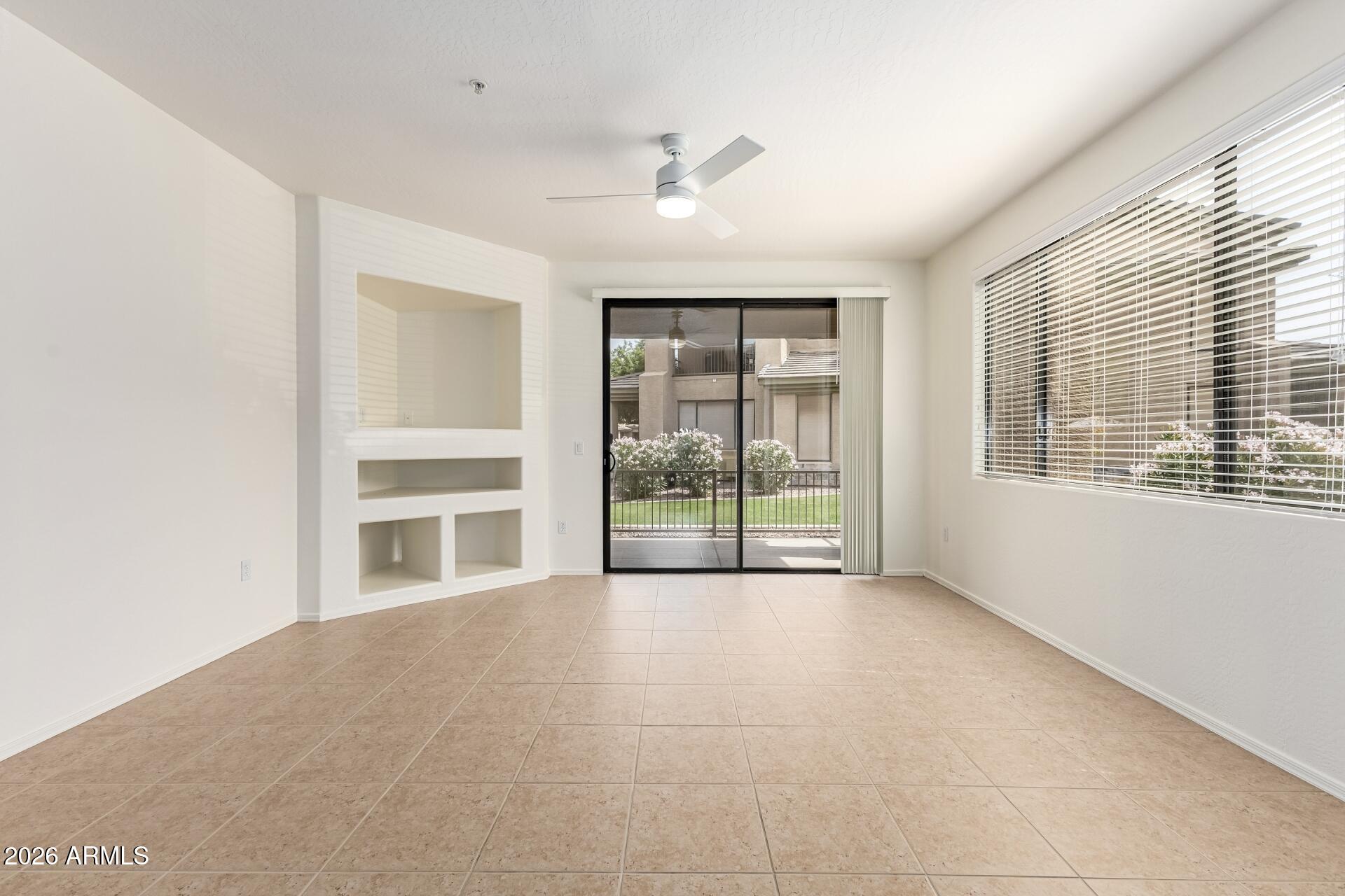 705 West Queen Creek Road, Unit 1167 Chandler, AZ 85248 - Photo 2 of 31 a view of an empty room with a fireplace and a window