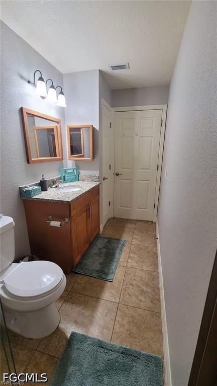 152 Pullman Street Lehigh Acres, FL 33974 - Photo 8 of 15 a bathroom with a toilet sink and mirror