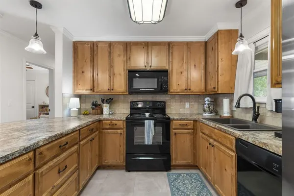 a kitchen with a sink stove and microwave