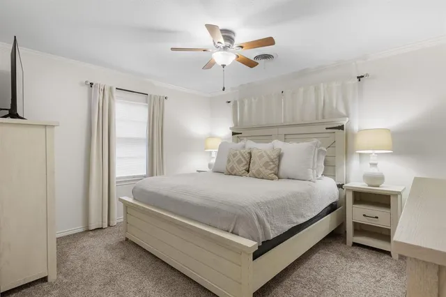 a bedroom with a bed and a ceiling fan