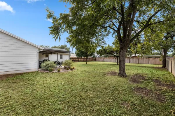 a view of a house with a backyard