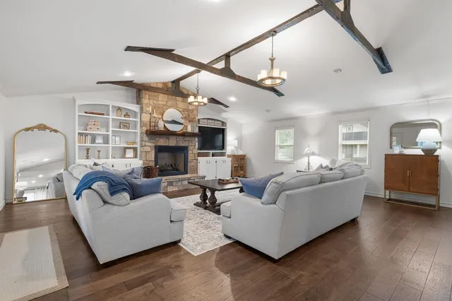 a living room with furniture wooden floor and a fireplace