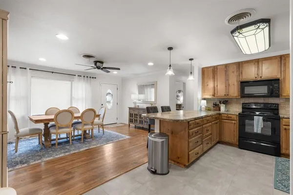 a large kitchen with a table and chairs