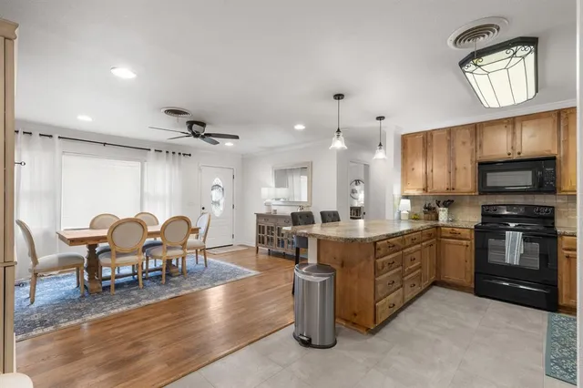 a large kitchen with a table and chairs
