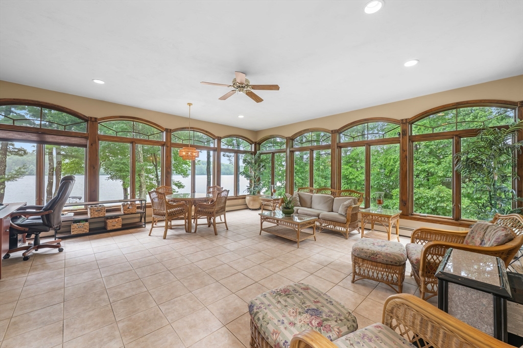 14 Demond Pond Row Rutland, MA 01543 - Photo 17 of 42 a living room with furniture and floor to ceiling windows