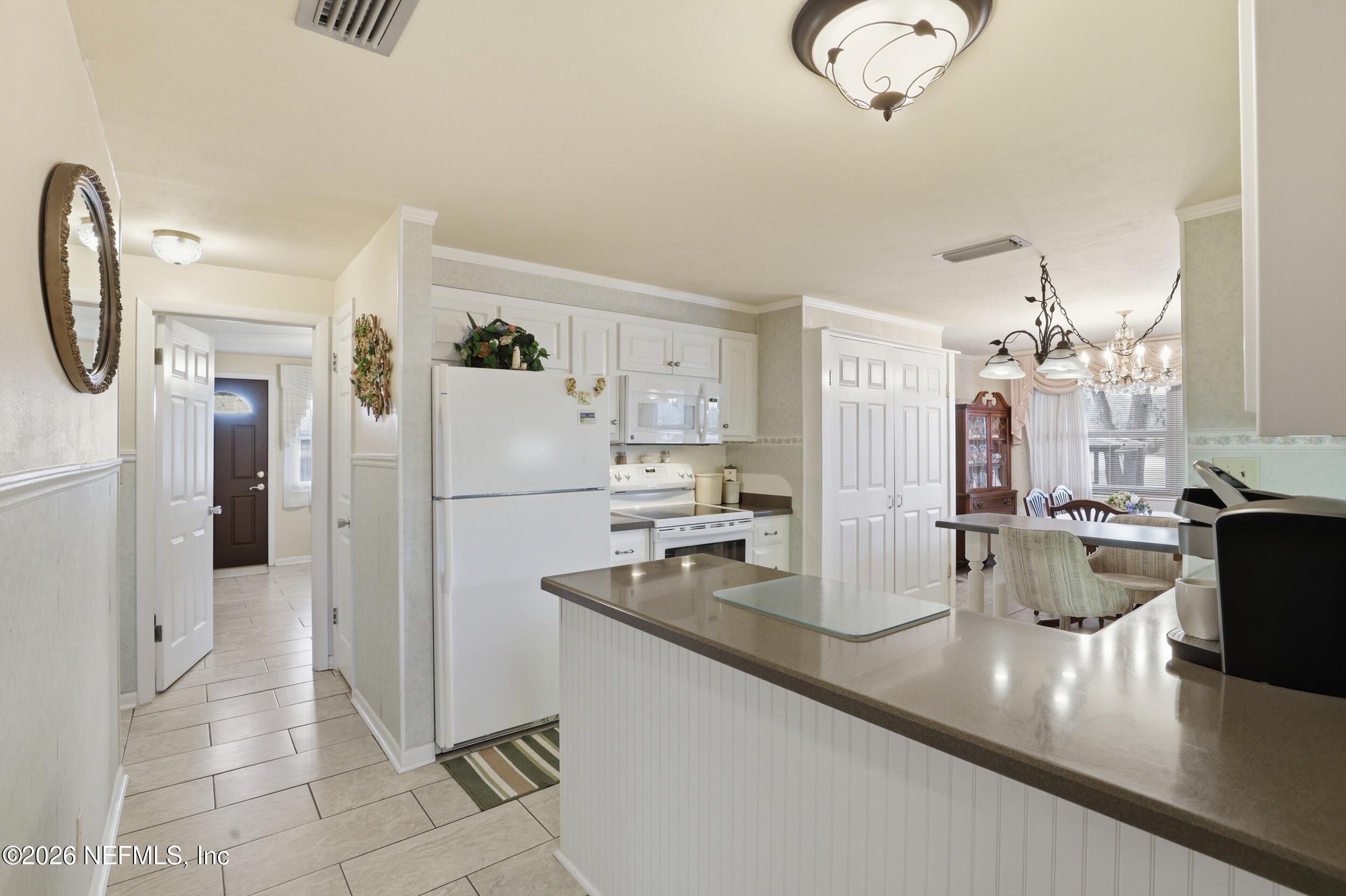 295 Northwest Berea Avenue Keystone Heights, FL 32656 - Photo 12 of 49 a kitchen with stainless steel appliances granite countertop a refrigerator and a sink