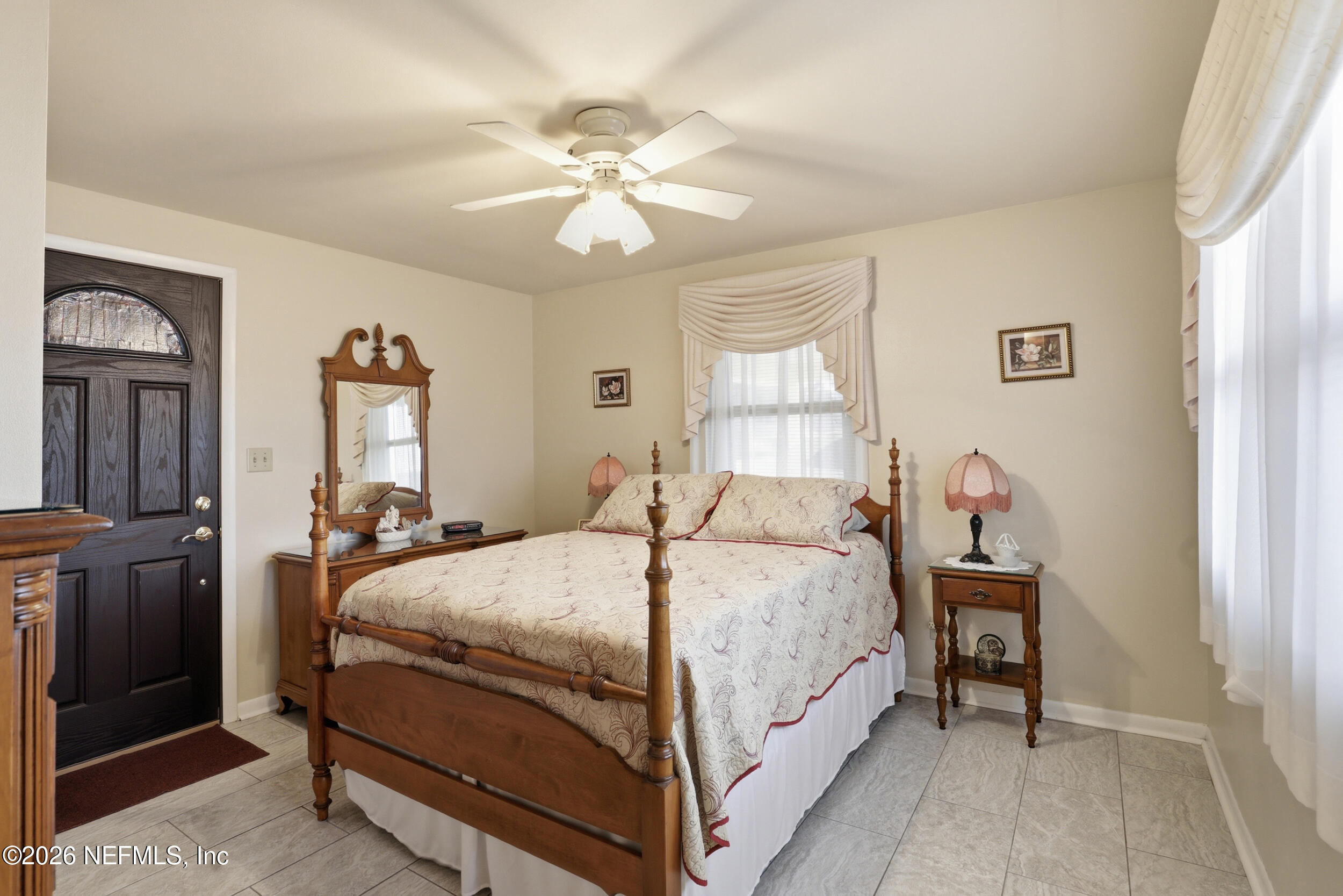 295 Northwest Berea Avenue Keystone Heights, FL 32656 - Photo 17 of 49 a bed room with a bed and a chandelier