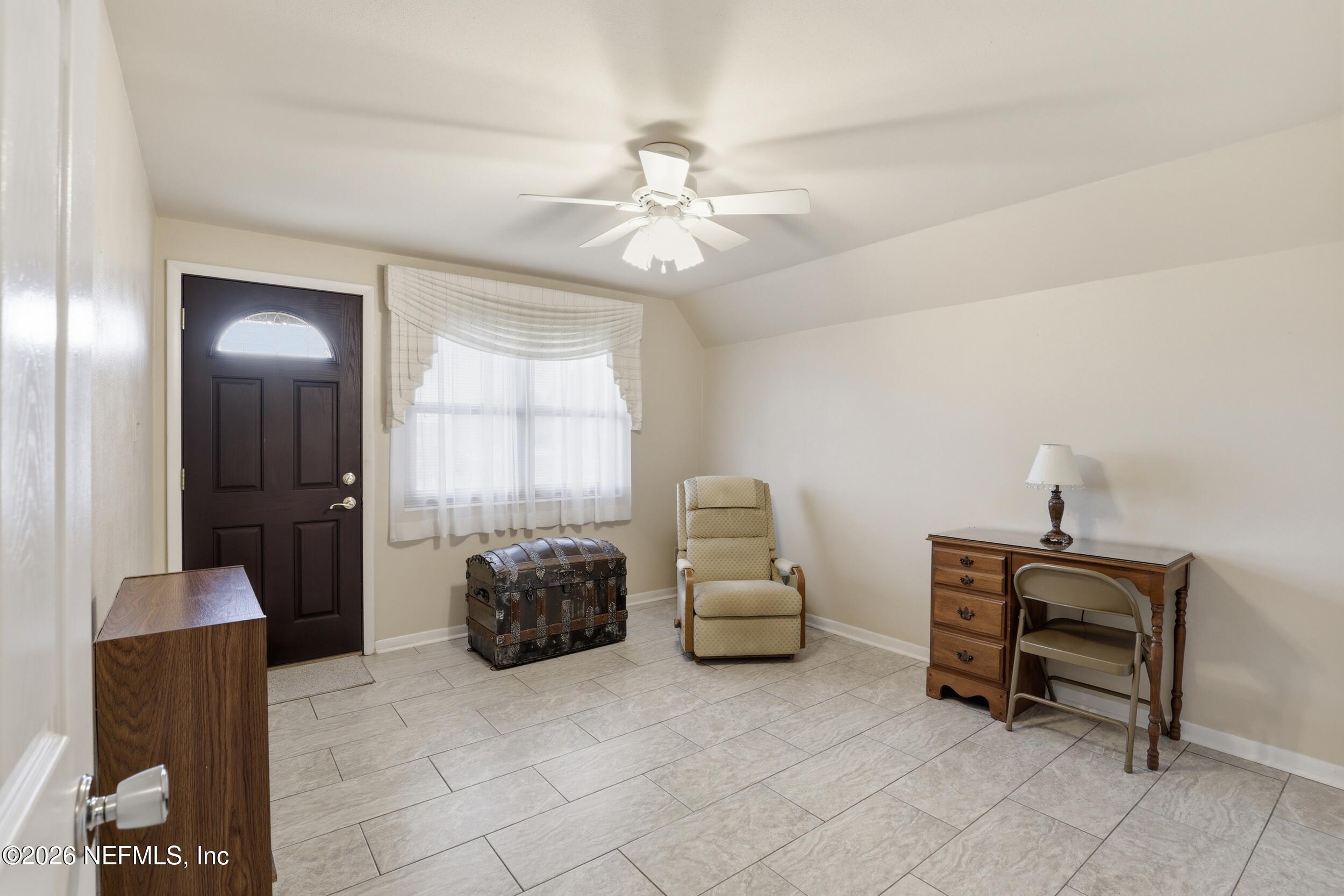 295 Northwest Berea Avenue Keystone Heights, FL 32656 - Photo 19 of 49 a living room with furniture and a chandelier