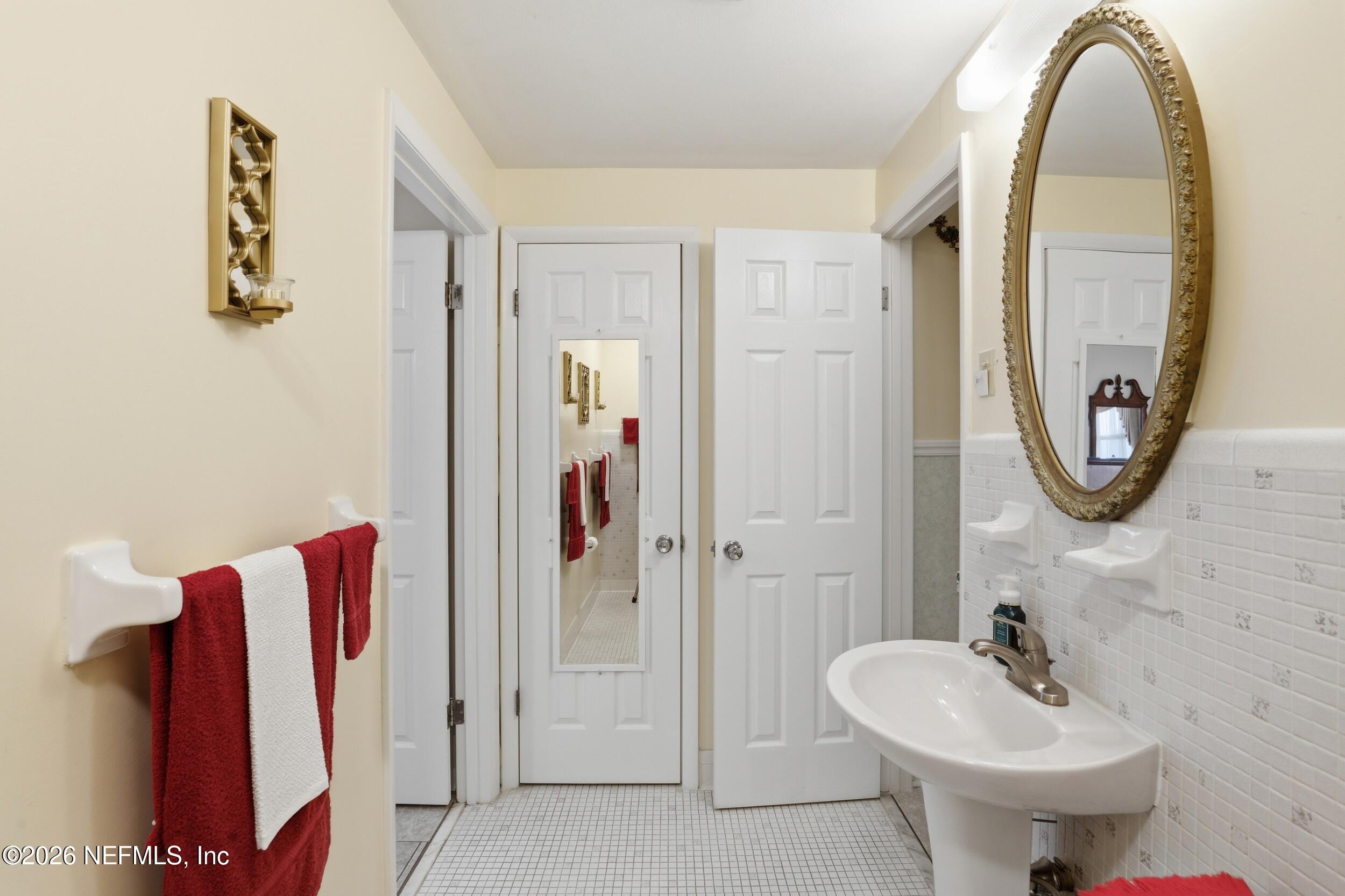 295 Northwest Berea Avenue Keystone Heights, FL 32656 - Photo 22 of 49 a bathroom with a sink and a mirror