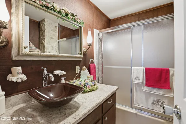 a bathroom with a sink and a mirror