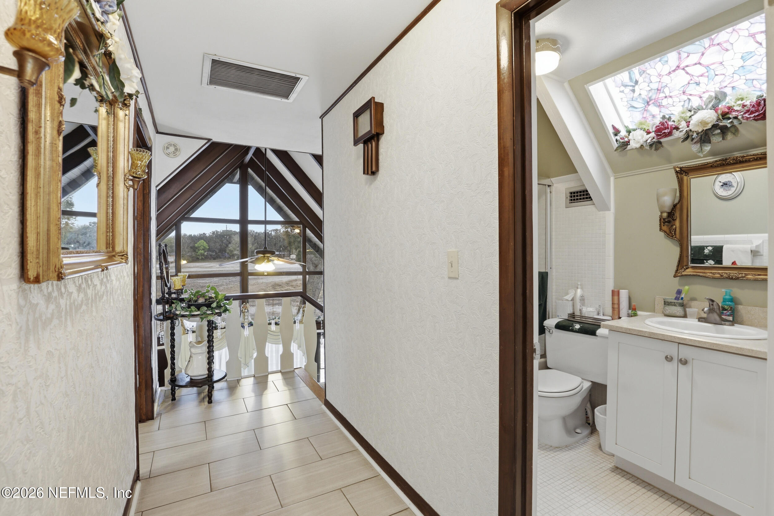 295 Northwest Berea Avenue Keystone Heights, FL 32656 - Photo 25 of 49 a bathroom with a toilet sink and mirror