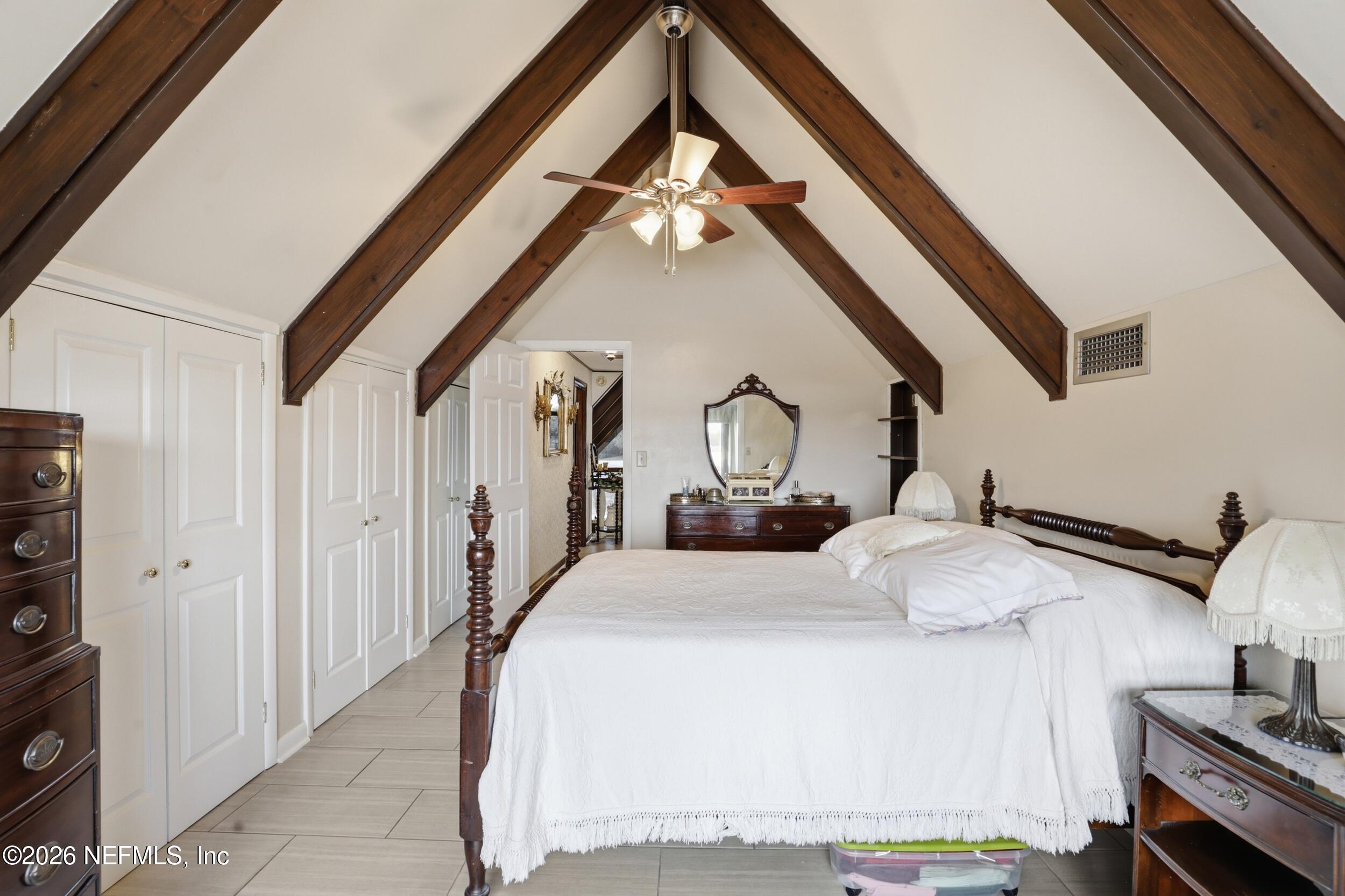 295 Northwest Berea Avenue Keystone Heights, FL 32656 - Photo 27 of 49 a bedroom with bed and a chandelier