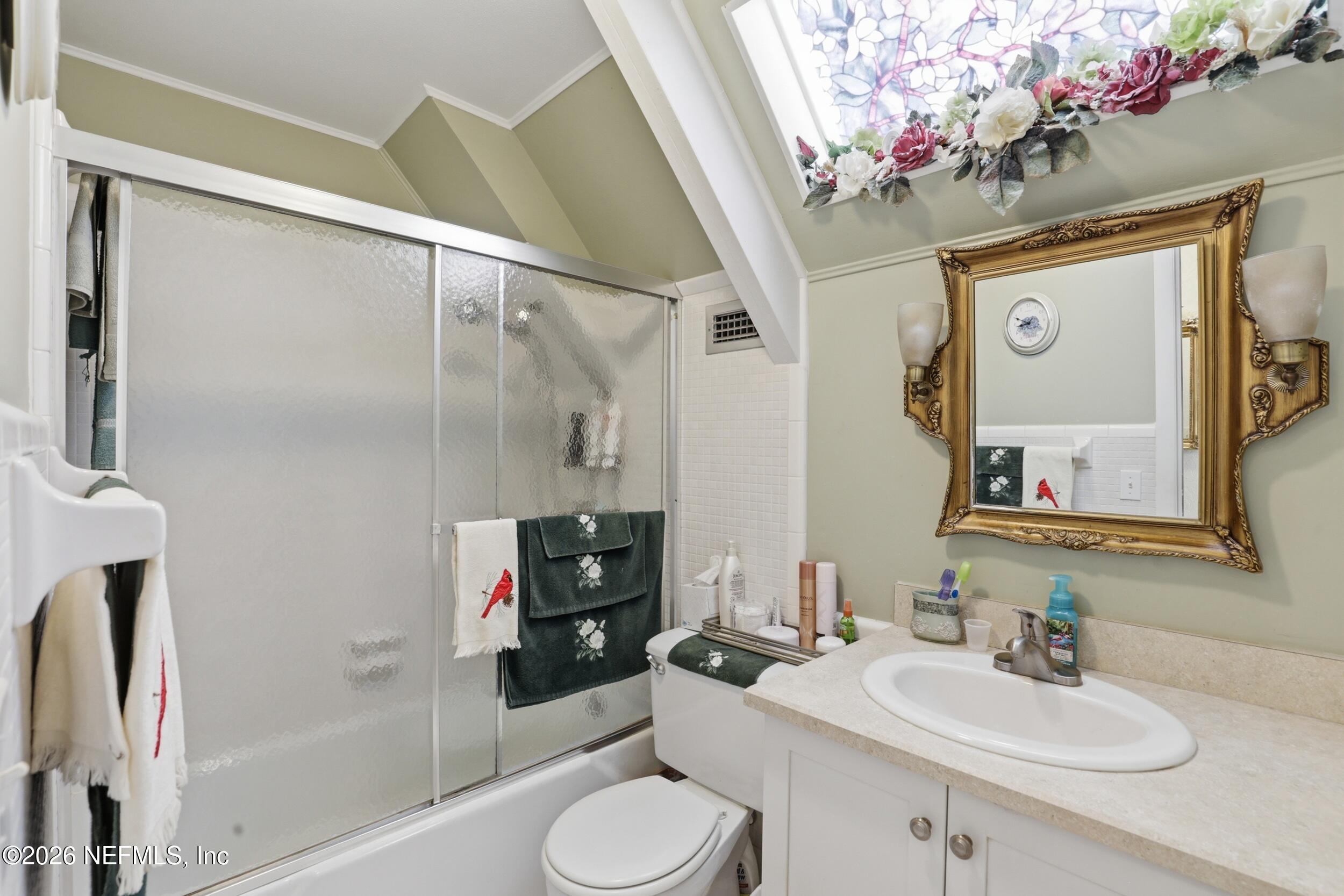 295 Northwest Berea Avenue Keystone Heights, FL 32656 - Photo 28 of 49 a bathroom with a sink vanity mirror and toilet