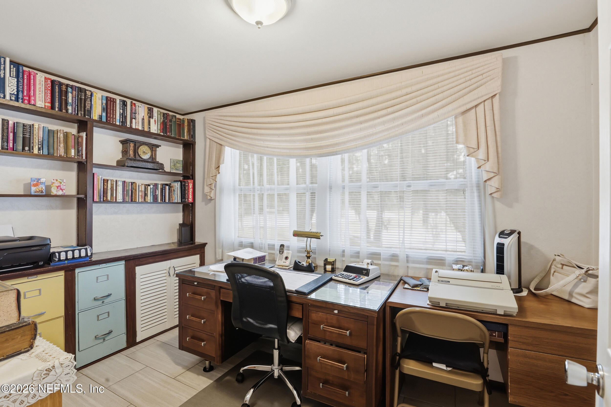 295 Northwest Berea Avenue Keystone Heights, FL 32656 - Photo 29 of 49 a view of a workspace with furniture and a window