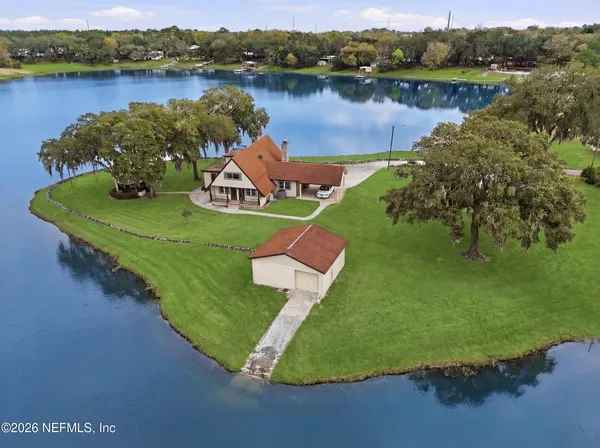 an aerial view of a house with a lake view