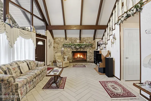 a living room with furniture a window and a fireplace