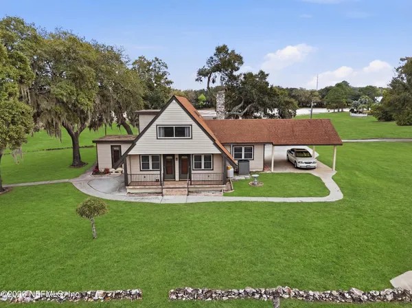 an aerial view of a house with pool fire pit and outdoor seating