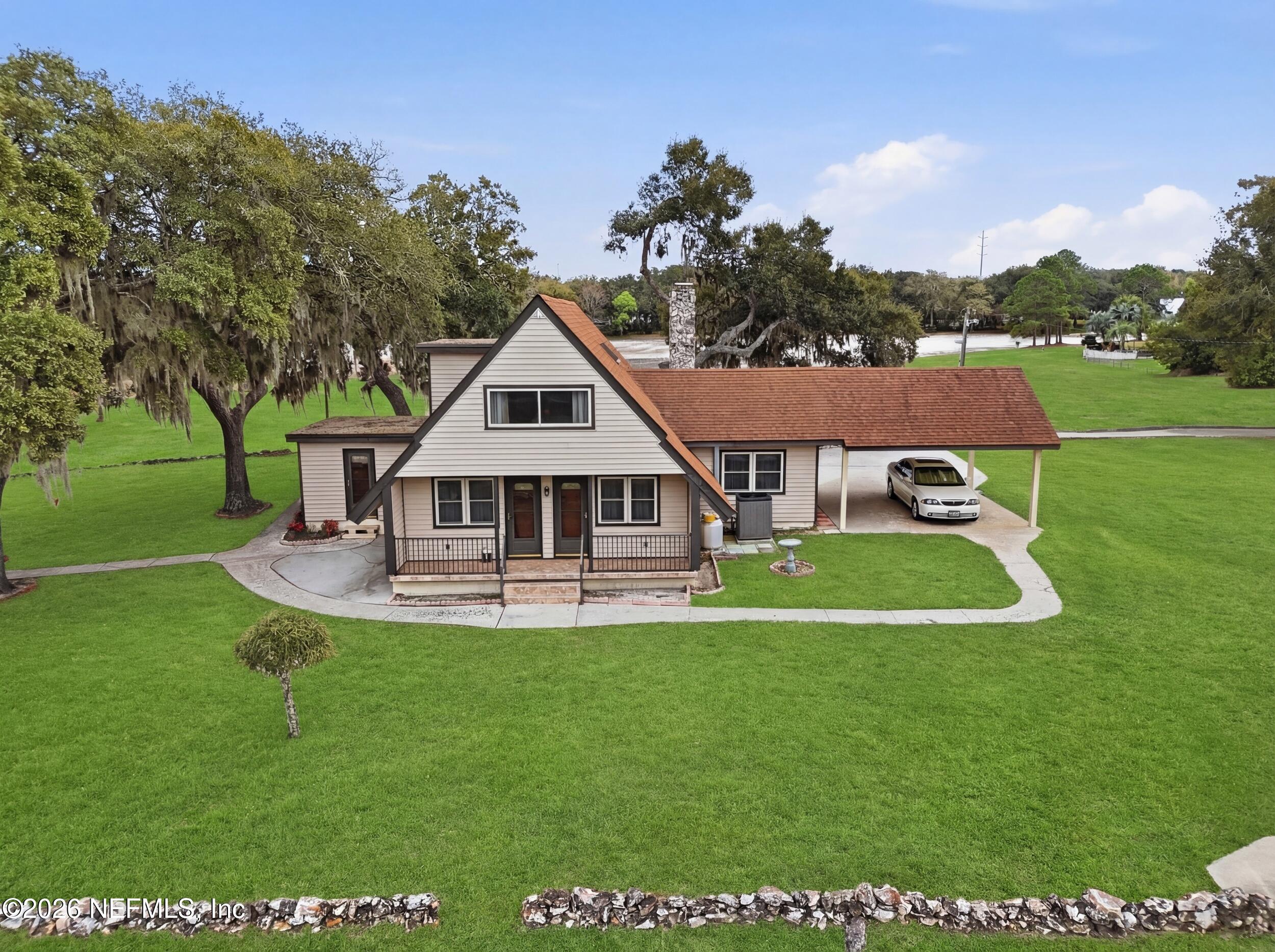 295 Northwest Berea Avenue Keystone Heights, FL 32656 - Photo 43 of 49 a front view of a house with garden