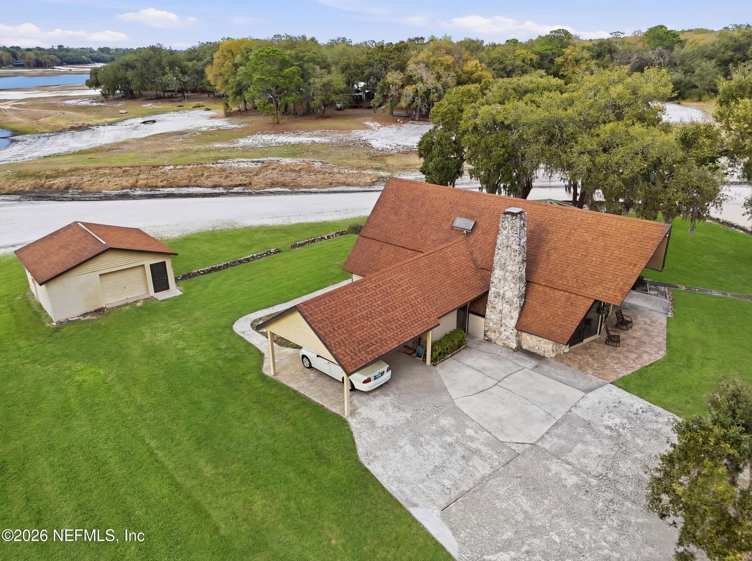 295 Northwest Berea Avenue Keystone Heights, FL 32656 - Photo 45 of 49 an aerial view of a house with pool fire pit and outdoor seating