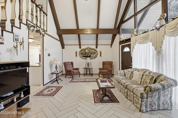 a living room with fireplace furniture and a chandelier