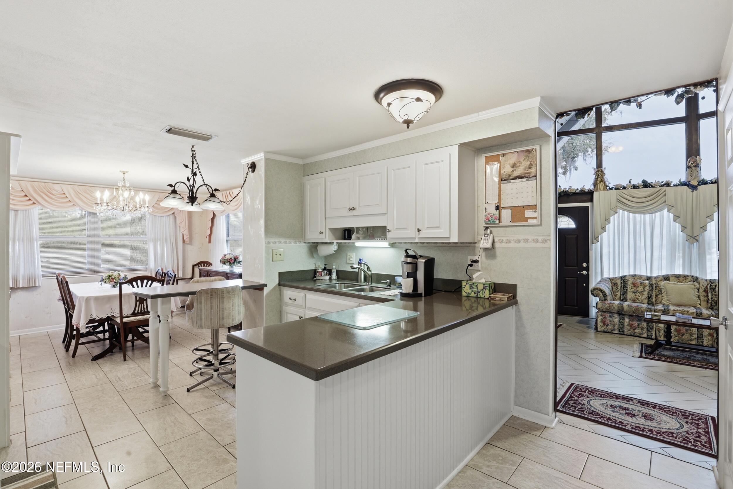 295 Northwest Berea Avenue Keystone Heights, FL 32656 - Photo 9 of 49 a kitchen with counter top space appliances and cabinets