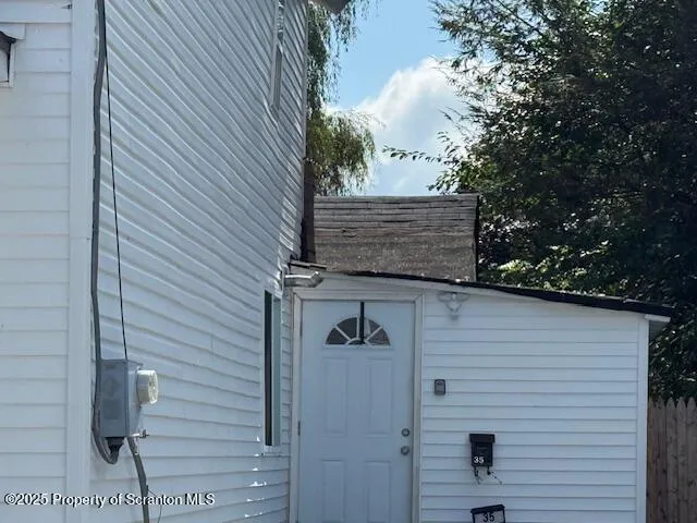 a view of wooden door and brick wall