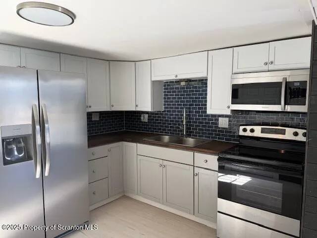 a kitchen with a refrigerator stove and microwave