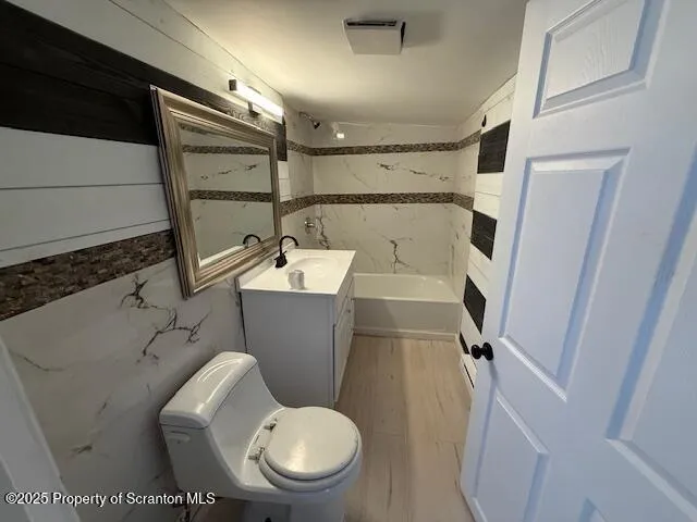 a white toilet sitting next to a bathroom sink