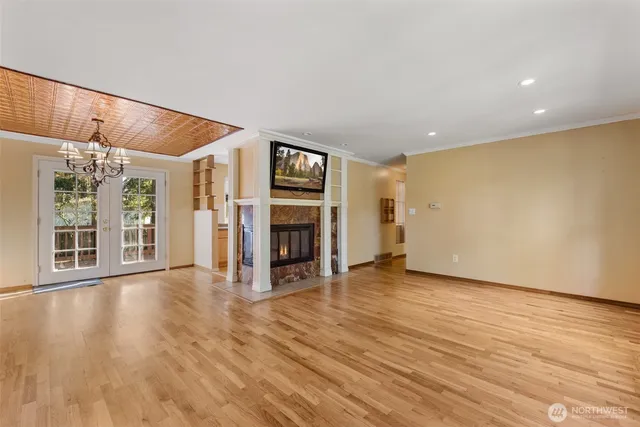 a view of a livingroom with wooden floor and a fireplace