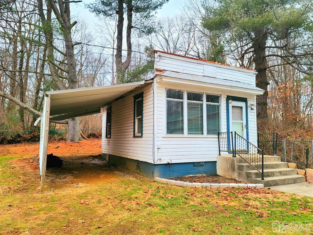 a view of house with yard outdoor seating and pathway
