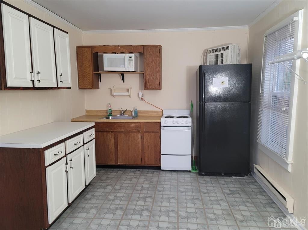 302 Schoolhouse Road, Unit B Monroe Township, NJ 08831 - Photo 2 of 8 a kitchen with a sink stove and refrigerator