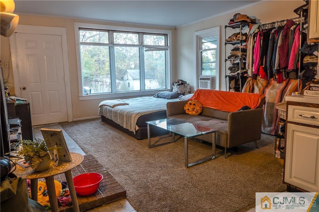 302 Schoolhouse Road, Unit B Monroe Township, NJ 08831 - Photo 4 of 8 a bedroom with furniture and a closet