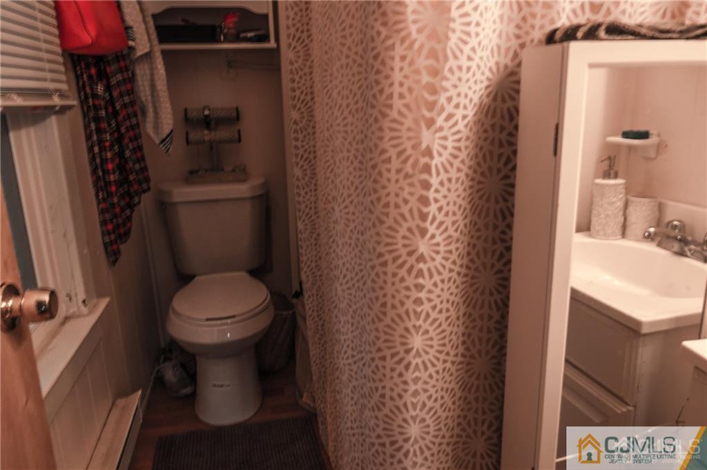 302 Schoolhouse Road, Unit B Monroe Township, NJ 08831 - Photo 6 of 8 a white toilet sitting next to a bathroom sink