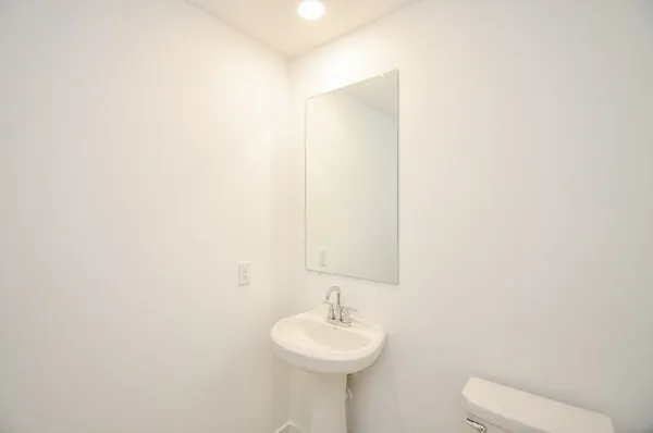 a bathroom with a sink a mirror and a toilet