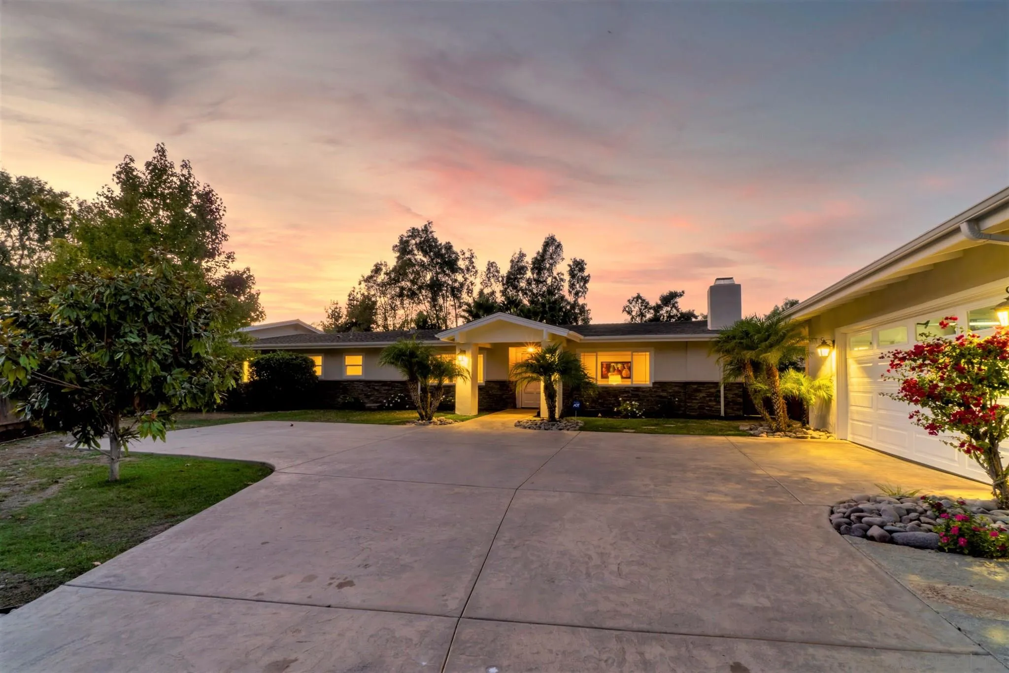a view of a house with a patio and a yard