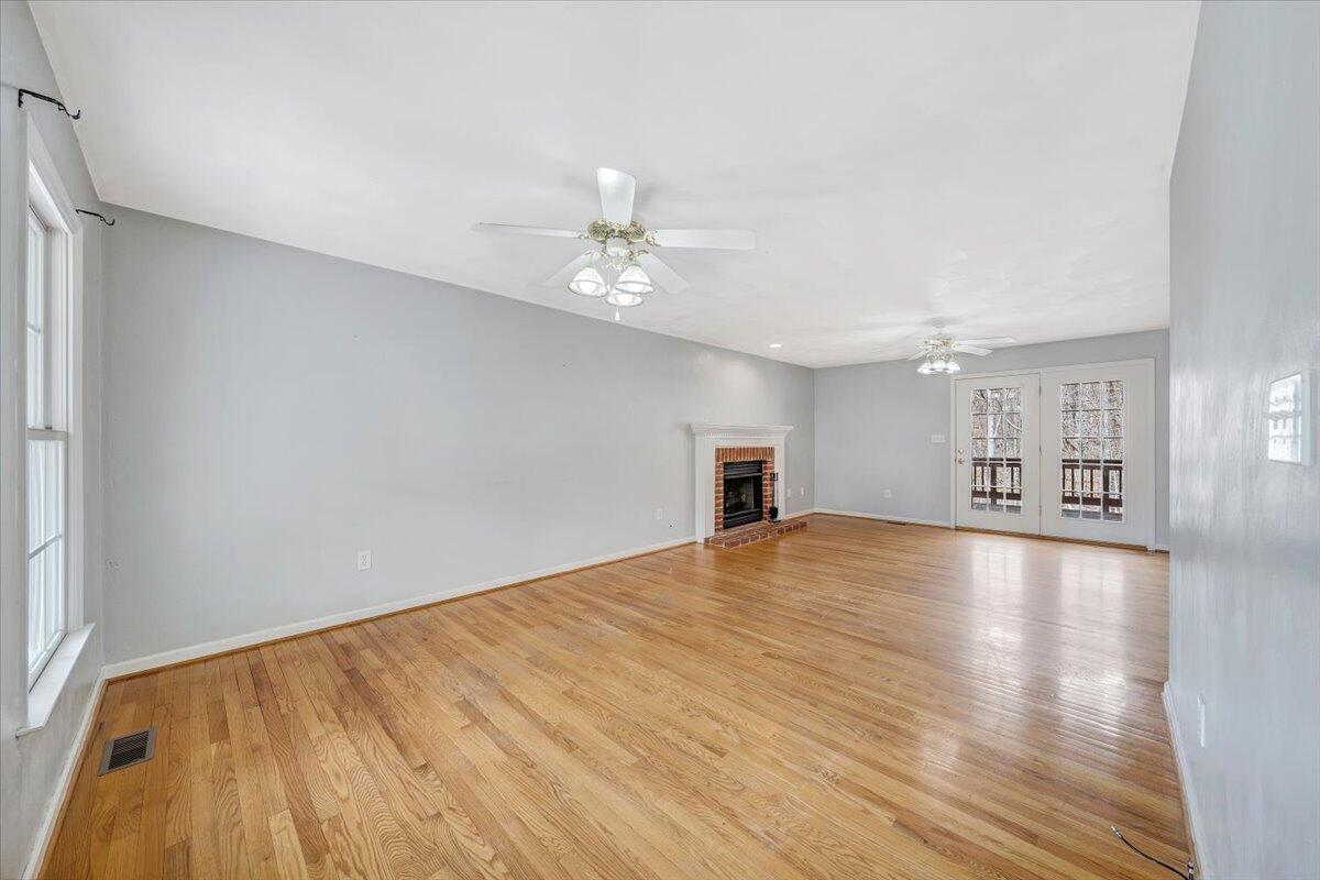 1063 Archway Road Blue Ridge, VA 24064 - Photo 4 of 46 a view of an empty room with window and wooden floor