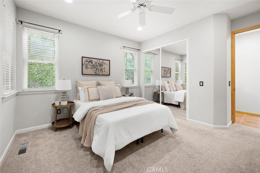 5982 Violeta Avenue Atascadero, CA 93422 - Photo 61 of 75 a spacious bedroom with a bed and a chandelier