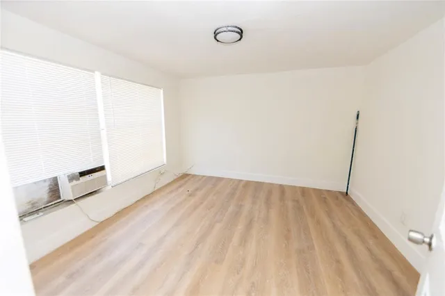 a view of a room with wooden floor and brick wall