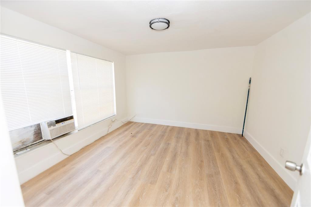 2510 Northeast 3rd Avenue Pompano Beach, FL 33064 - Photo 12 of 23 a view of a room with wooden floor and brick wall