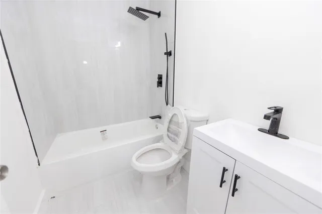 a bathroom with a sink a toilet and a bathtub