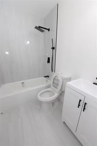 a bathroom with a sink a toilet and tub
