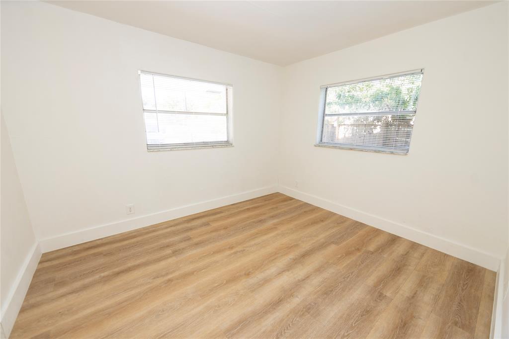 2510 Northeast 3rd Avenue Pompano Beach, FL 33064 - Photo 17 of 23 an empty room with wooden floor and windows