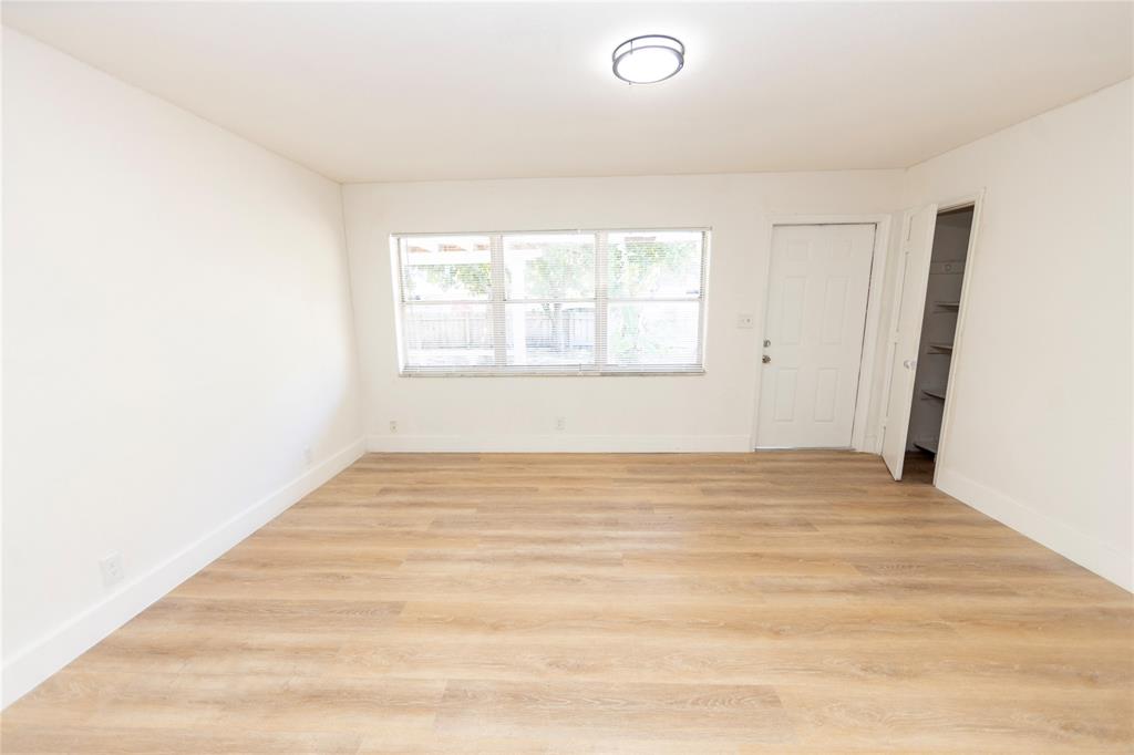 2510 Northeast 3rd Avenue Pompano Beach, FL 33064 - Photo 23 of 23 an empty room with wooden floor and windows