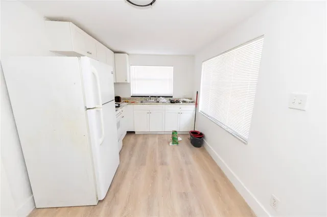 a view of a kitchen with wooden floor