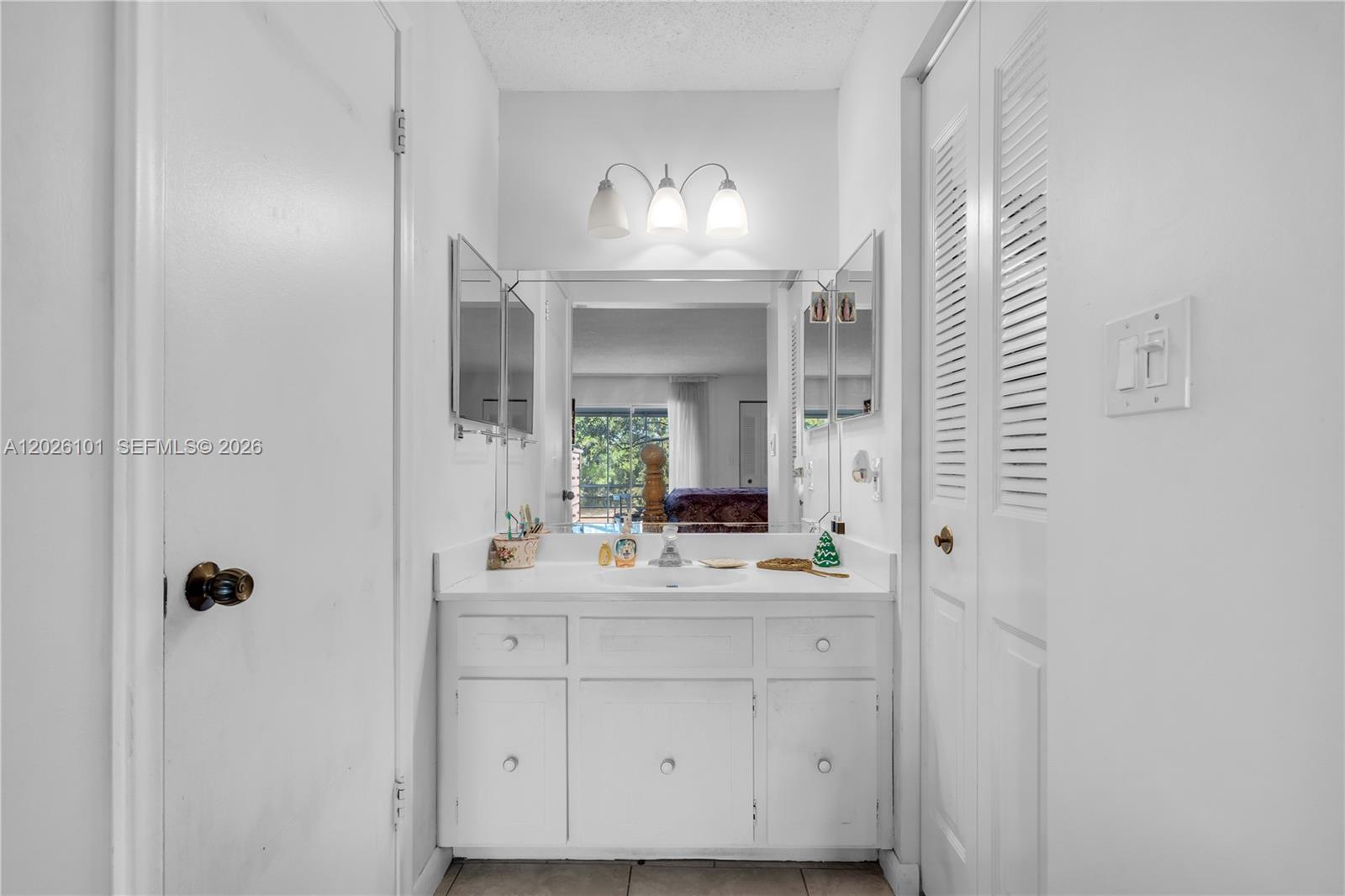 3551 Inverrary Drive, Unit 208 Lauderhill, FL 33319 - Photo 11 of 34 a bathroom with a sink vanity and mirror