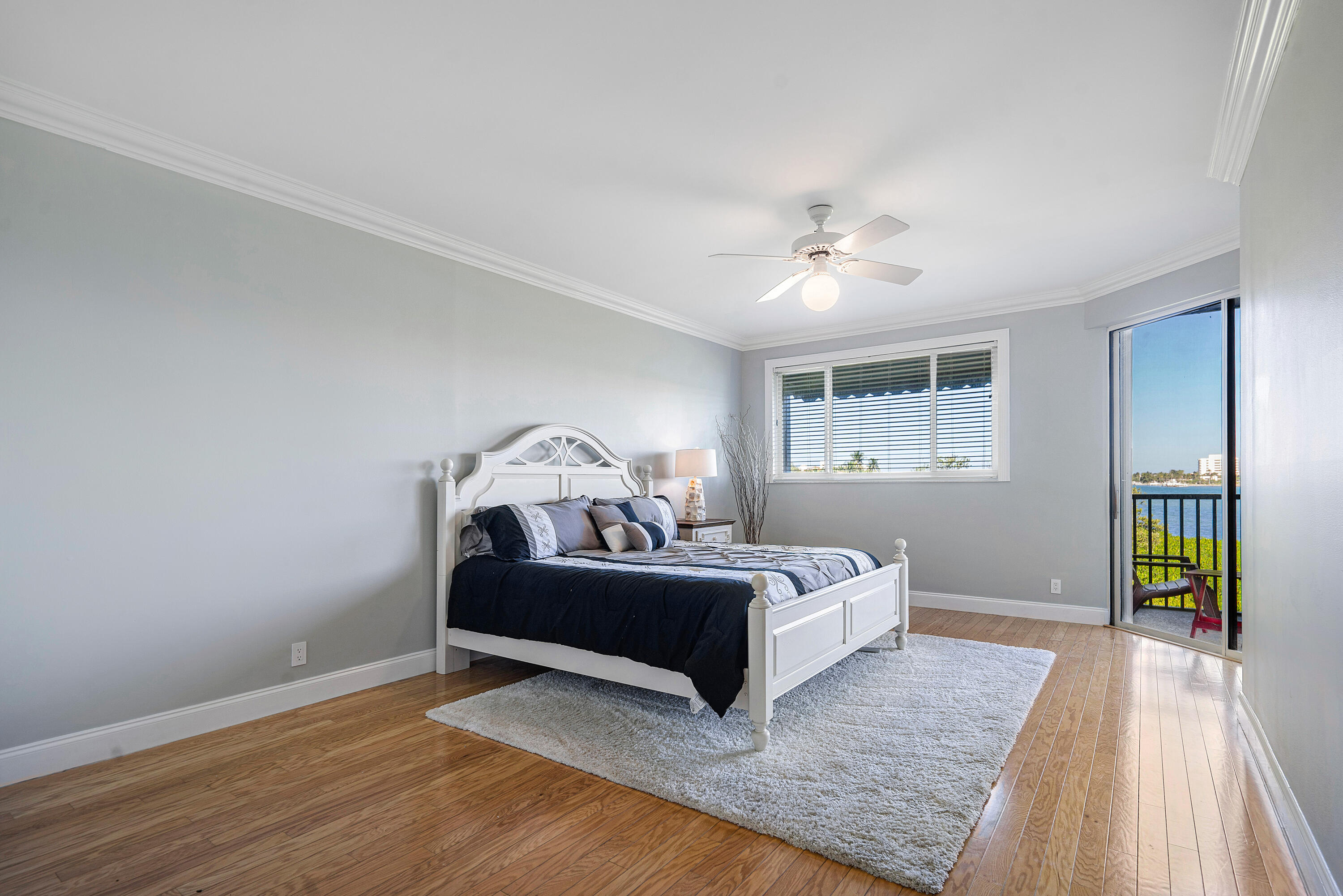 200 Waterway Road, Unit 204 Tequesta, FL 33469 - Photo 15 of 34 a bedroom with a bed and a chandelier