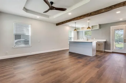 a view of kitchen and hall with wooden floor